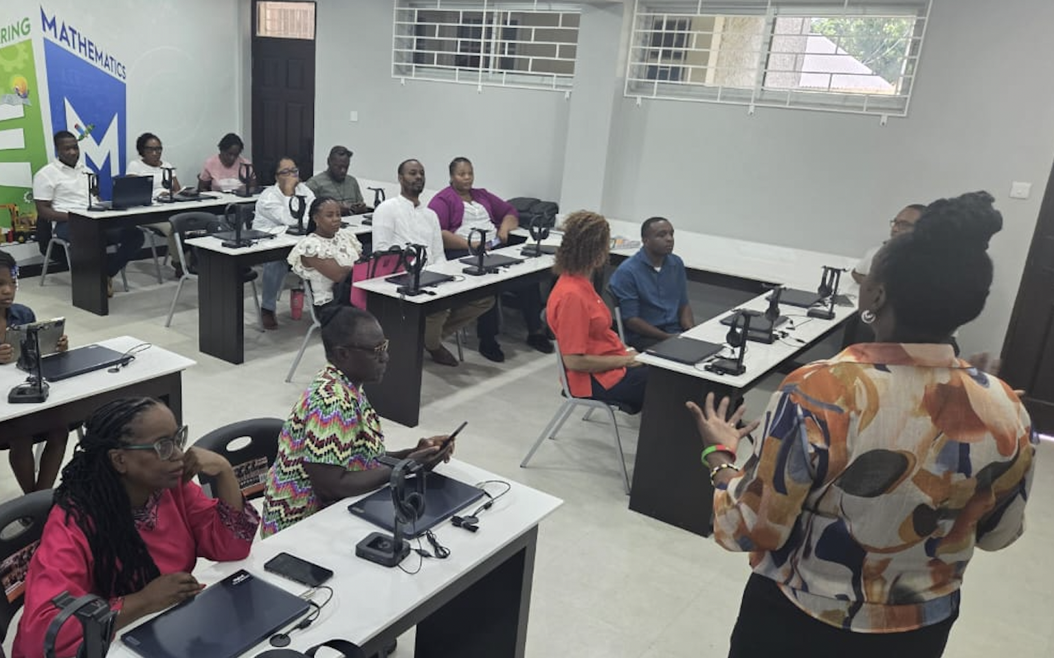 A CASE classroom with teachers seated at computers during the CURIOV8 workshop.